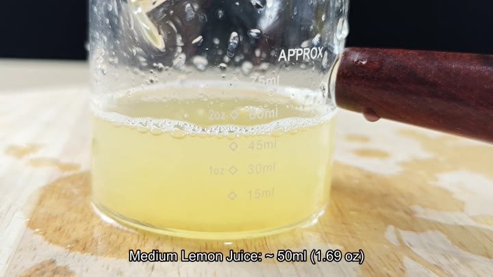 Measuring cup showing medium lemon juice volume Measuring cup showing medium lemon juice volume