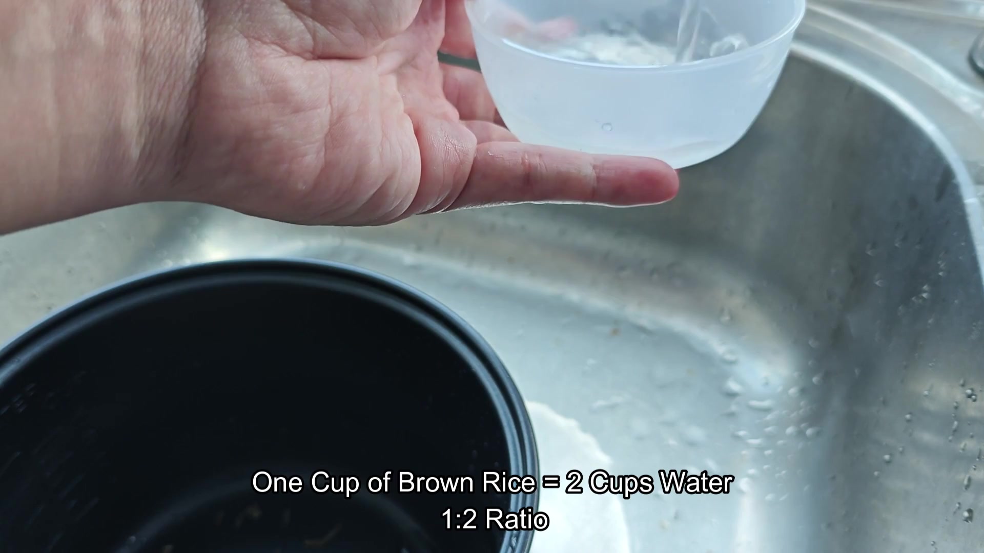 Measuring two cups of water for cooking Measuring two cups of water for cooking