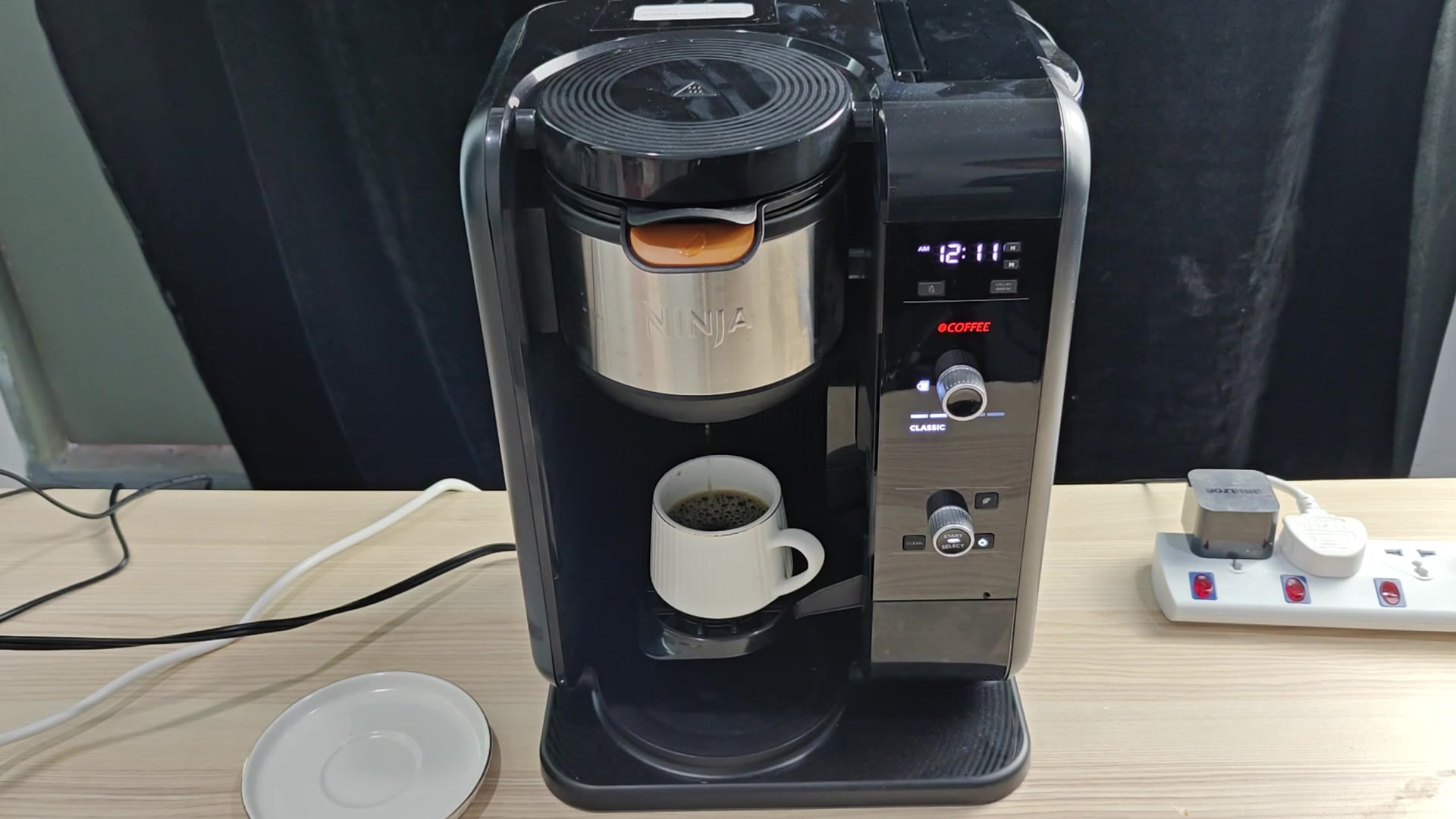 Ninja dispensing coffee into mug Ninja dispensing coffee into mug