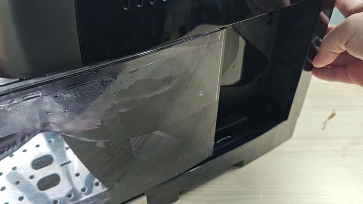 Opening condensation covered air fryer door Opening condensation covered air fryer door