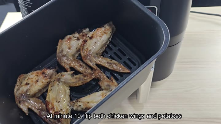 Partially cooked browned chicken wings in basket Partially cooked browned chicken wings in basket