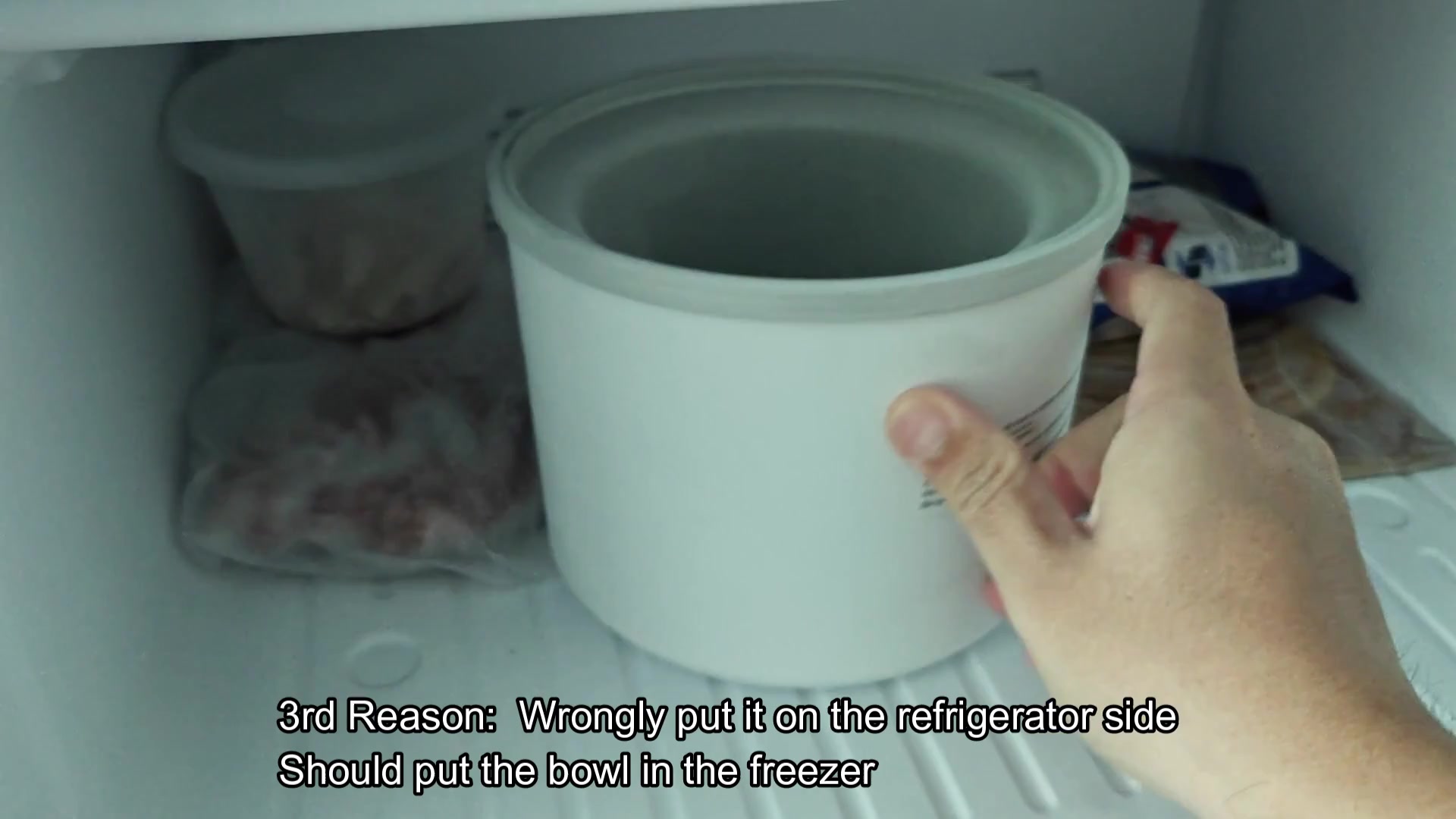Placing white bowl into freezer shelf Placing white bowl into freezer shelf