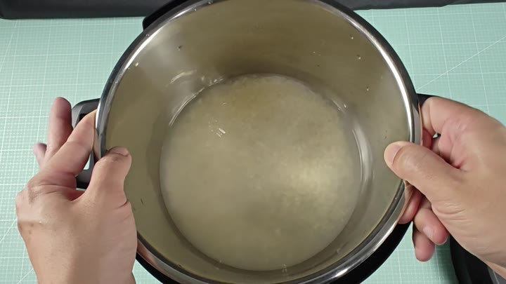 Pot contains water and uncooked rice Pot contains water and uncooked rice
