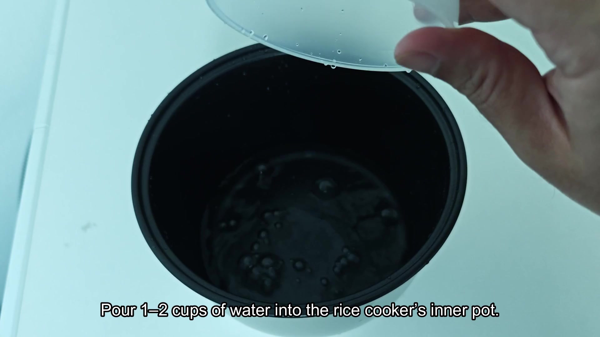Pour water into Aroma rice cooker pot Pour water into Aroma rice cooker pot