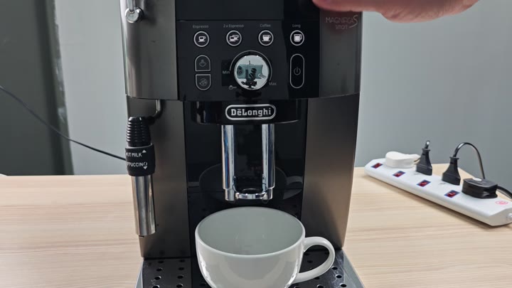 Pressing button on DeLonghi Magnifica panel Pressing button on DeLonghi Magnifica panel