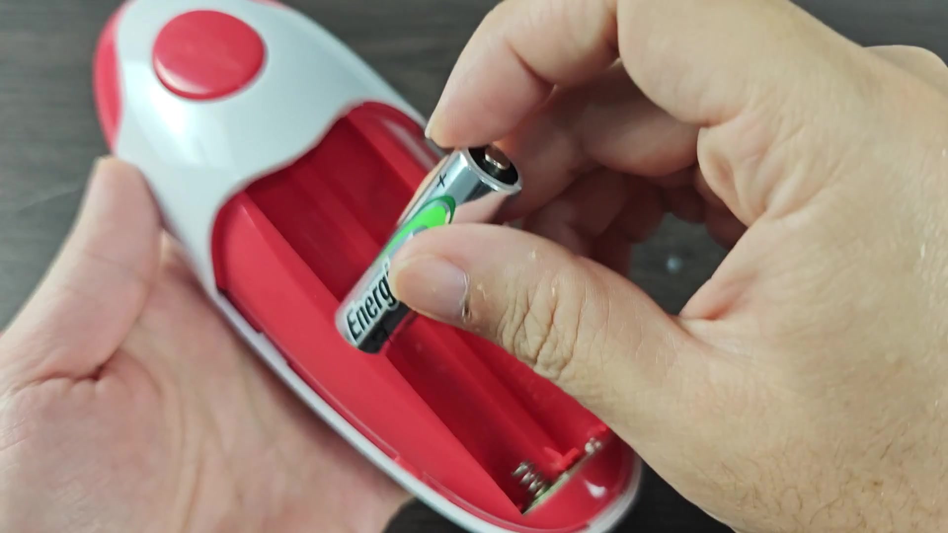 Pressing red plastic cover near contacts Pressing red plastic cover near contacts