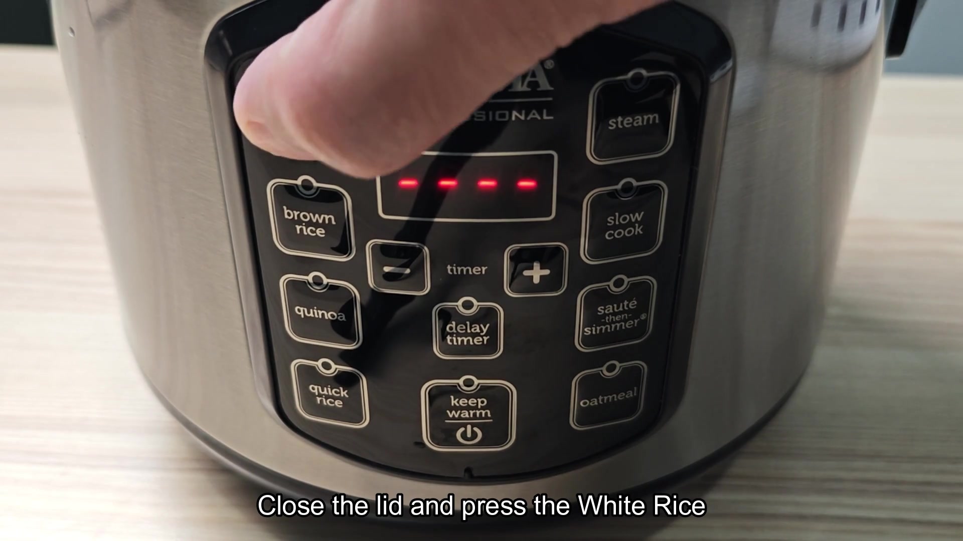 Pressing white rice button on cooker Pressing white rice button on cooker