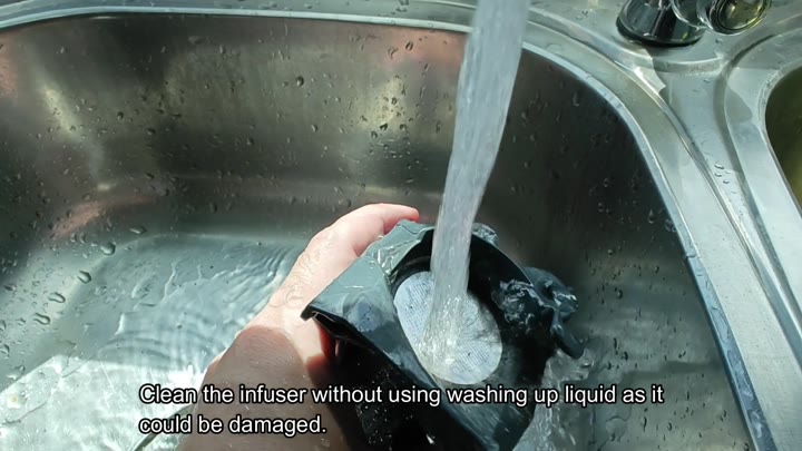 Rinsing black infuser under running water Rinsing black infuser under running water