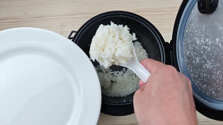 Scooping cooked jasmine rice onto plate Scooping cooked jasmine rice onto plate