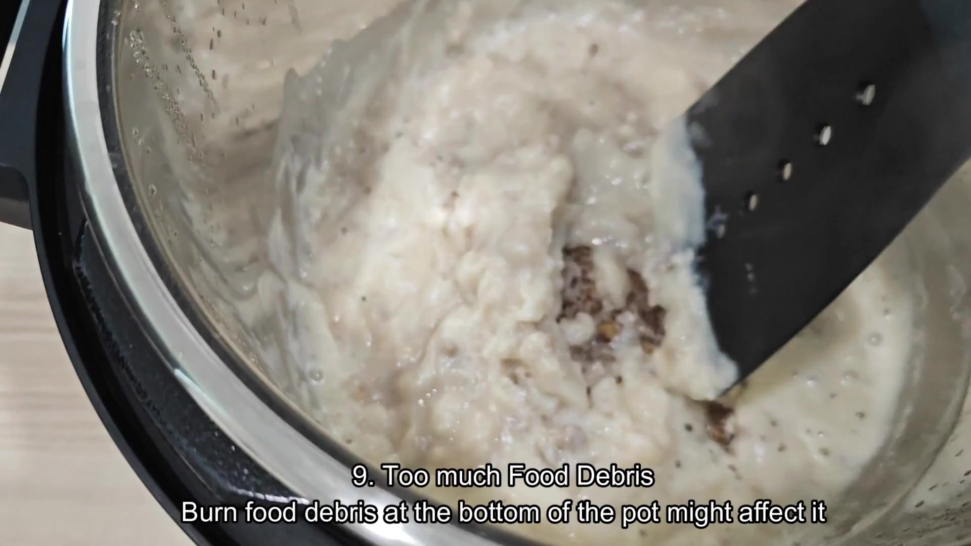 Scraping burnt food residue from bottom Scraping burnt food residue from bottom