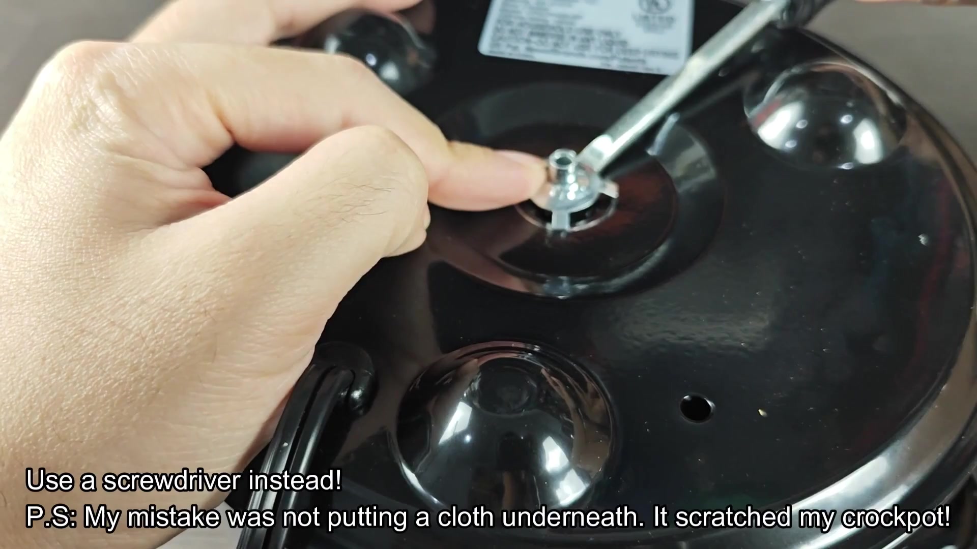 Screwdriver removing central fastener from base Screwdriver removing central fastener from base