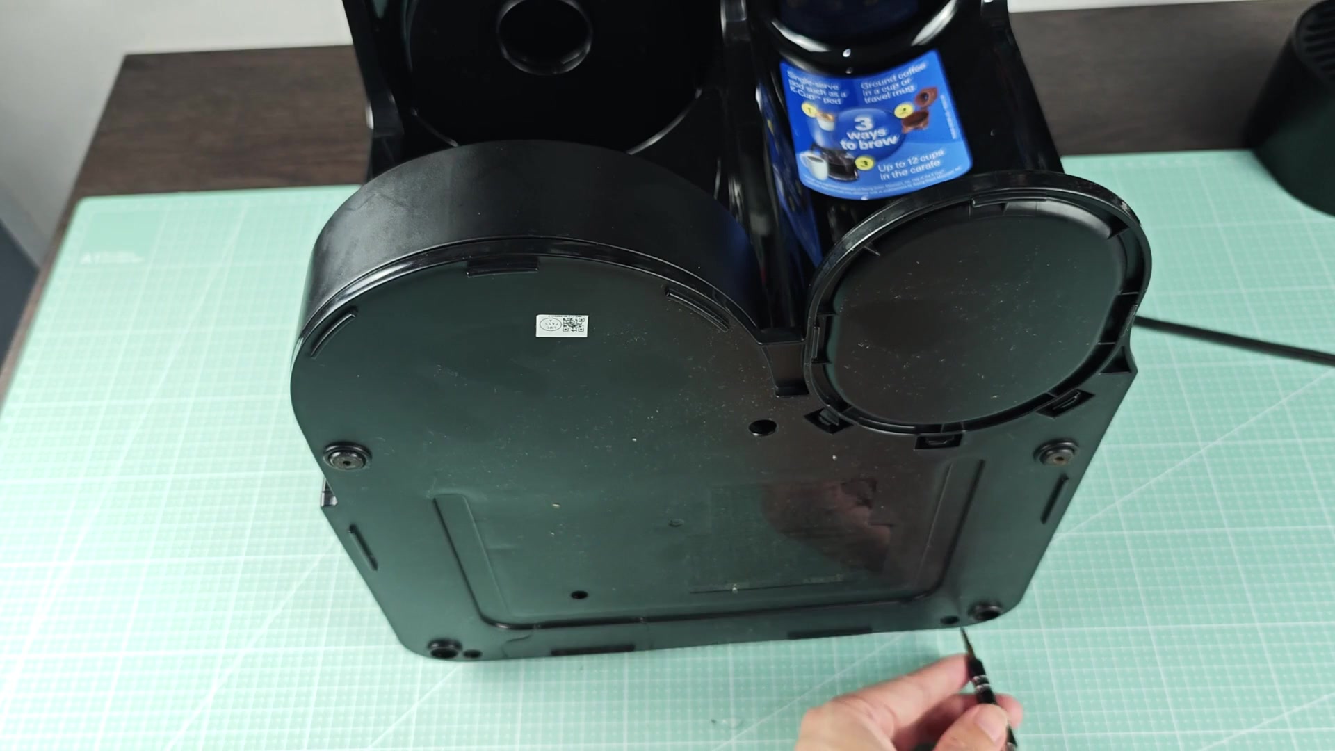 Screwing off bottom panel of machine Screwing off bottom panel of machine