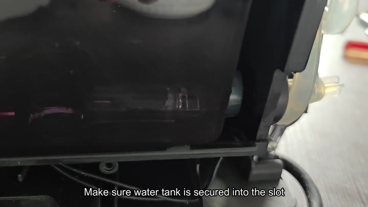 Securing the water tank into slot Securing the water tank into slot