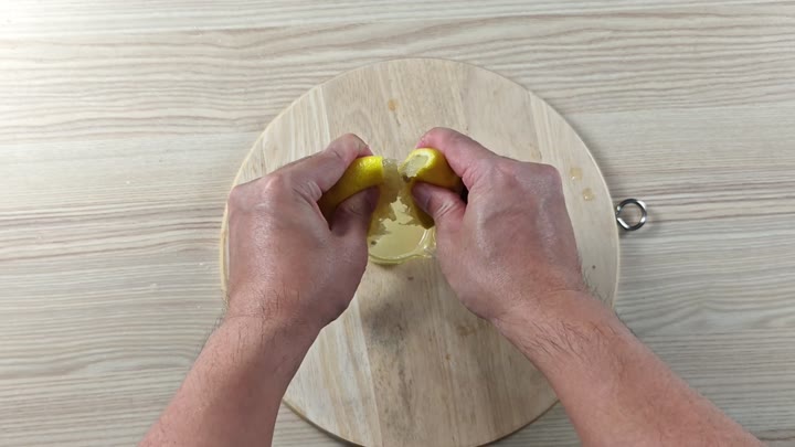 Squeezing lemon juice into a bowl Squeezing lemon juice into a bowl