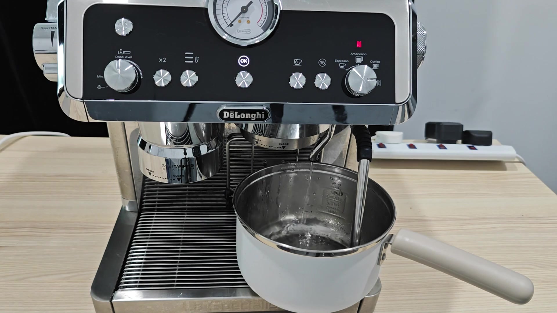 Steam wand agitating liquid in pitcher Steam wand agitating liquid in pitcher