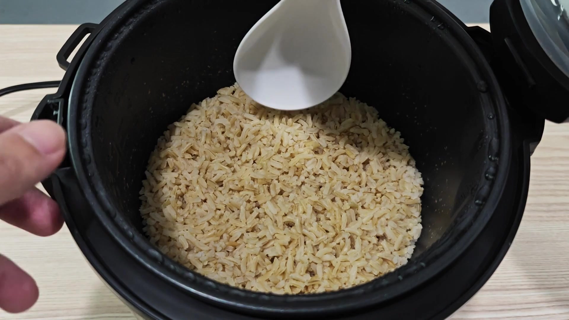 Stirring the hot cooked rice gently Stirring the hot cooked rice gently