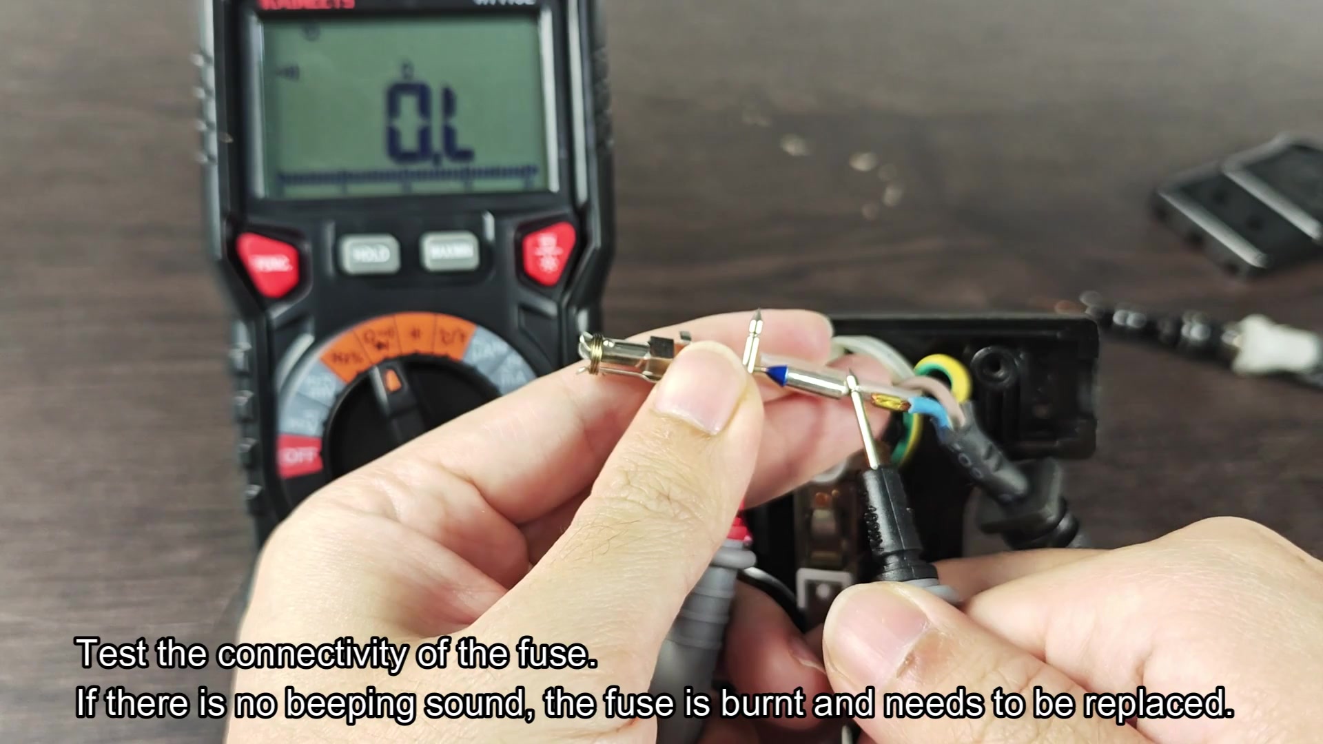 Test fuse connectivity with digital multimeter probe Test fuse connectivity with digital multimeter probe