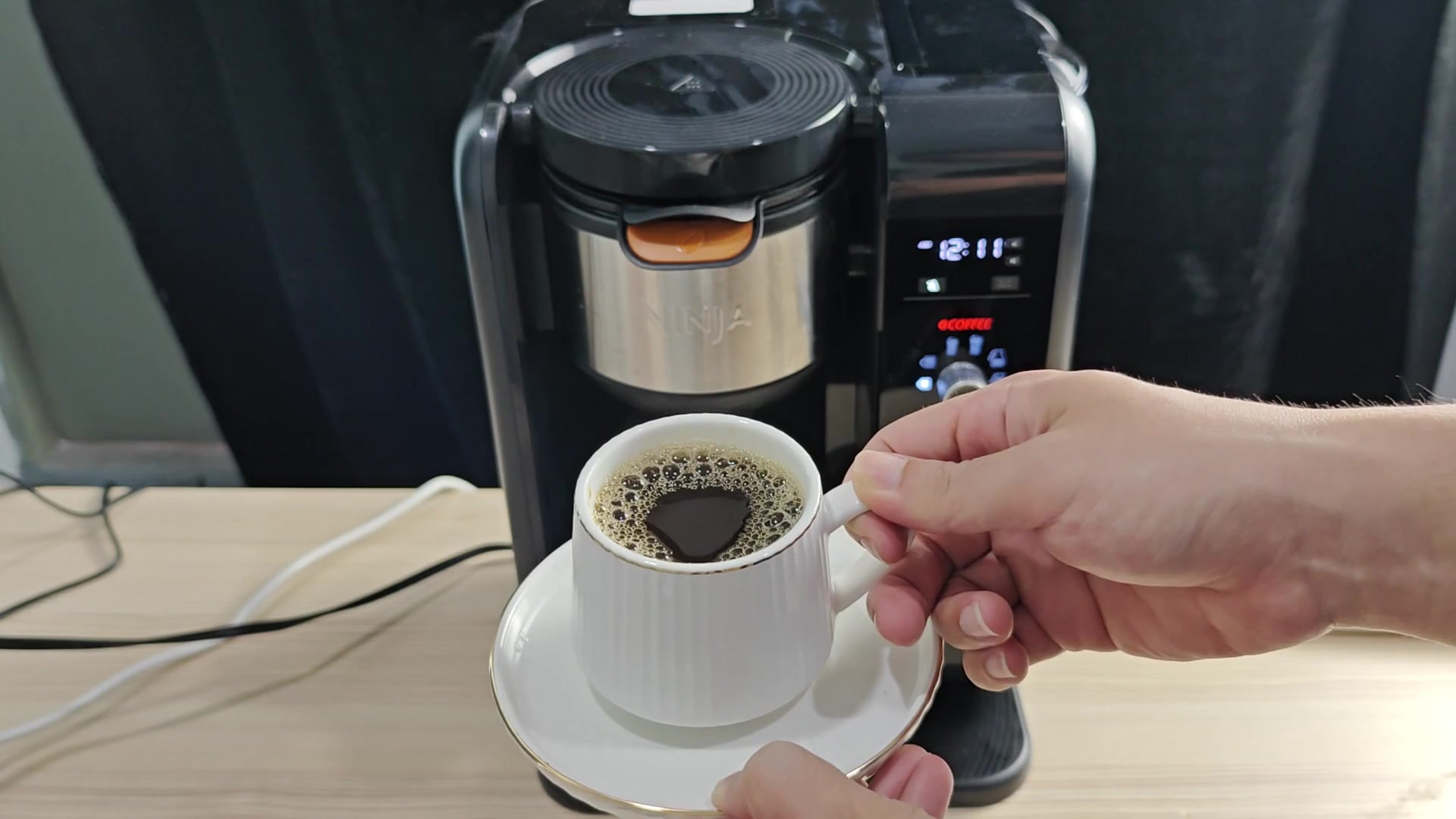White cup of coffee held up White cup of coffee held up