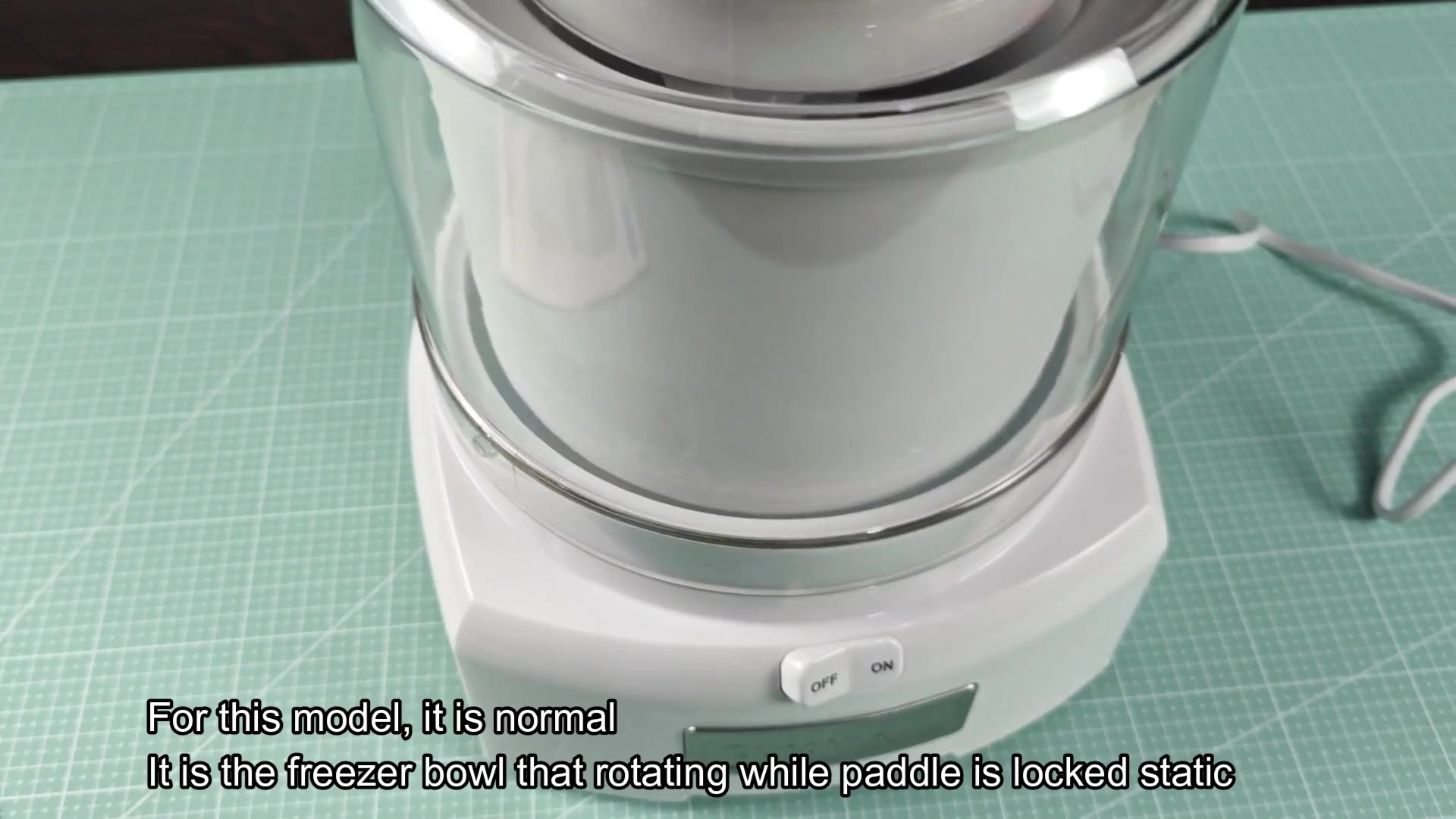 White ice cream maker base on green mat White ice cream maker base on green mat