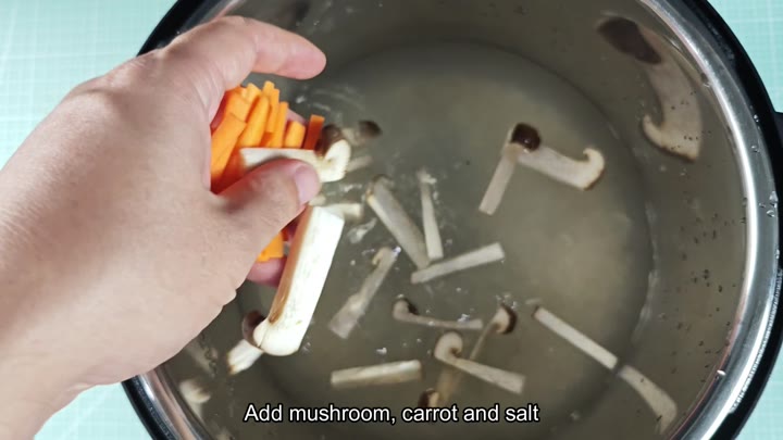 Adding mushrooms and carrots to pot Adding mushrooms and carrots to pot
