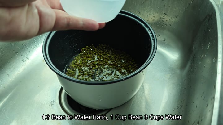 Adding water to beans in pot Adding water to beans in pot