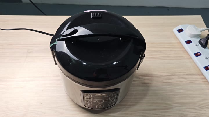 AROMA rice cooker on wooden surface AROMA rice cooker on wooden surface