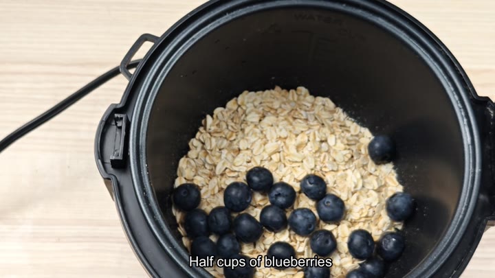 Blueberries added to oats in pot Blueberries added to oats in pot