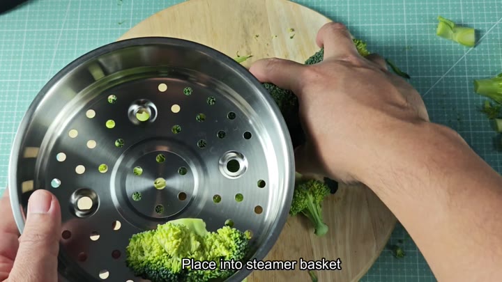 Broccoli florets in steamer basket Broccoli florets in steamer basket
