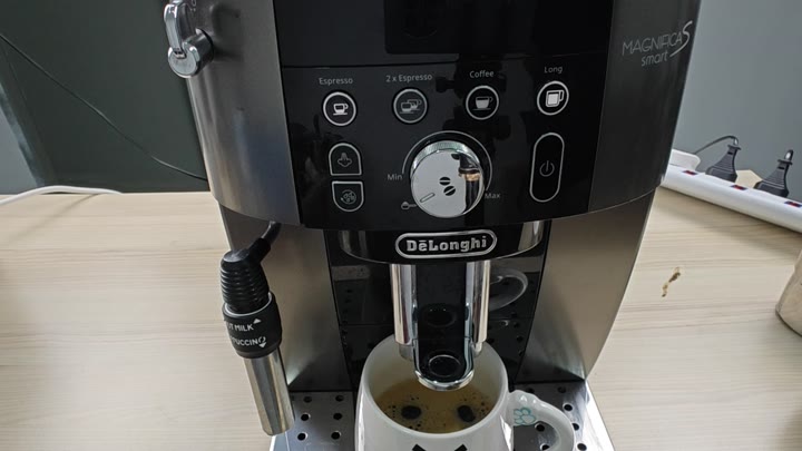 Coffee dispensing into cup from Magnifica Coffee dispensing into cup from Magnifica