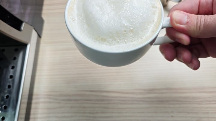 Cup of coffee topped with microfoam Cup of coffee topped with microfoam