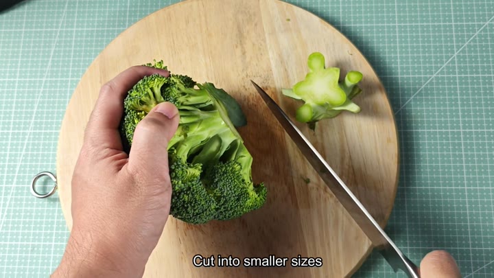 Cutting broccoli into smaller pieces Cutting broccoli into smaller pieces
