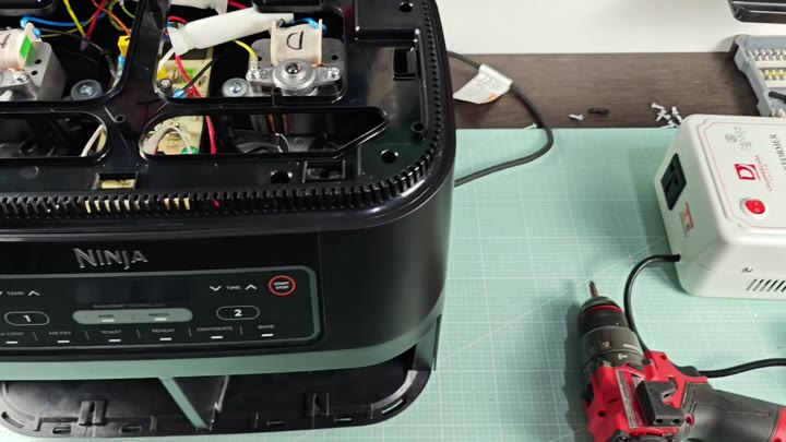 Disassembled air fryer with exposed wiring Disassembled air fryer with exposed wiring