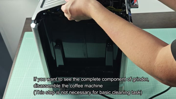 Disassembling the machine to expose the grinder Disassembling the machine to expose the grinder