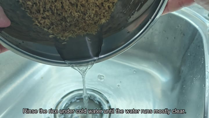 Draining rinsed brown rice in a bowl Draining rinsed brown rice in a bowl