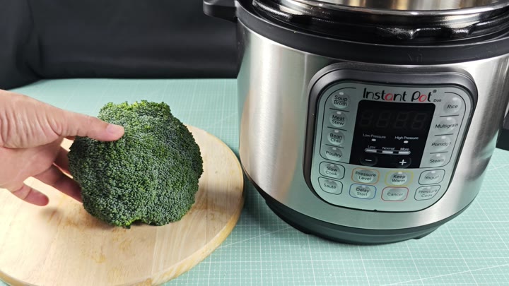 Fresh broccoli next to Instant Pot Fresh broccoli next to Instant Pot