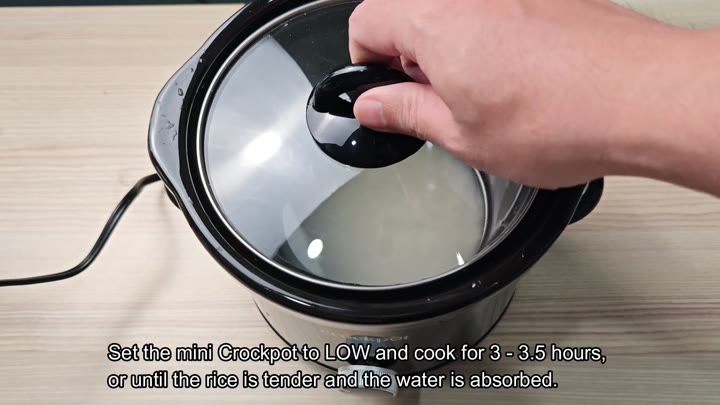 Glass lid being placed on mini Crockpot Glass lid being placed on mini Crockpot