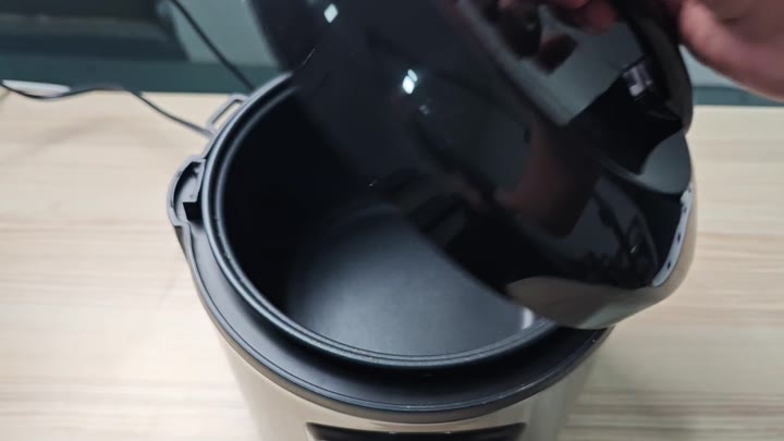 Lifting lid to reveal cooking pot Lifting lid to reveal cooking pot