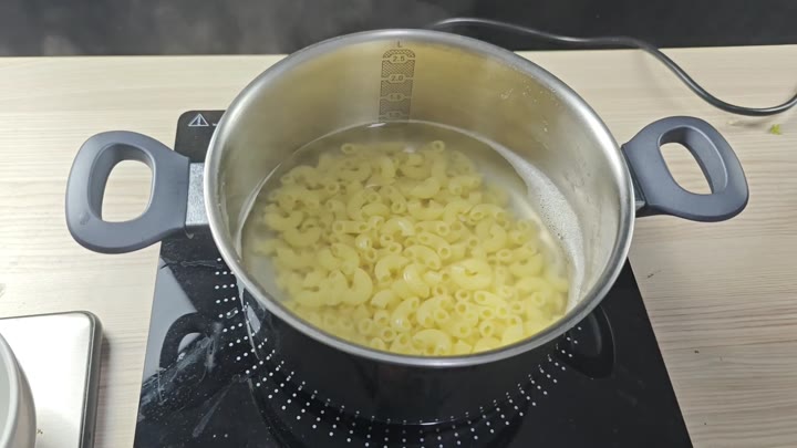 Macaroni boiling in stainless steel pot Macaroni boiling in stainless steel pot