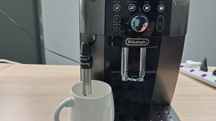 Machine dispensing steam into mug Machine dispensing steam into mug