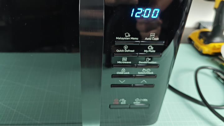 Microwave clock showing 12:00 on display Microwave clock showing 12:00 on display