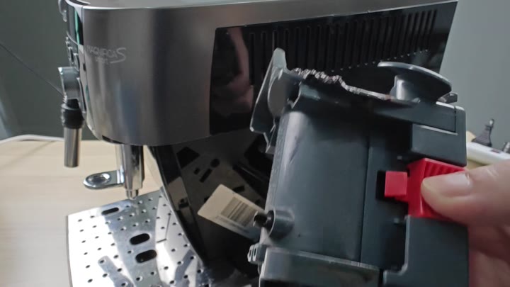Operating red lever on grinder Operating red lever on grinder