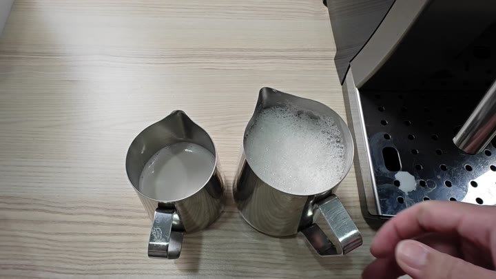 Pitchers showing frothed versus smooth milk Pitchers showing frothed versus smooth milk
