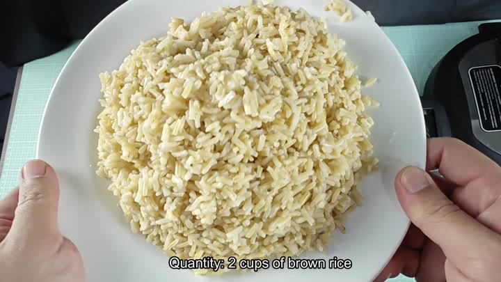 Plate of cooked brown rice on counter Plate of cooked brown rice on counter