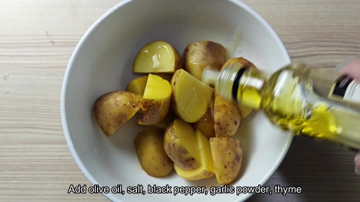 Pouring olive oil onto chopped potatoes Pouring olive oil onto chopped potatoes