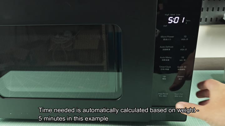 Pressing start button on microwave panel Pressing start button on microwave panel