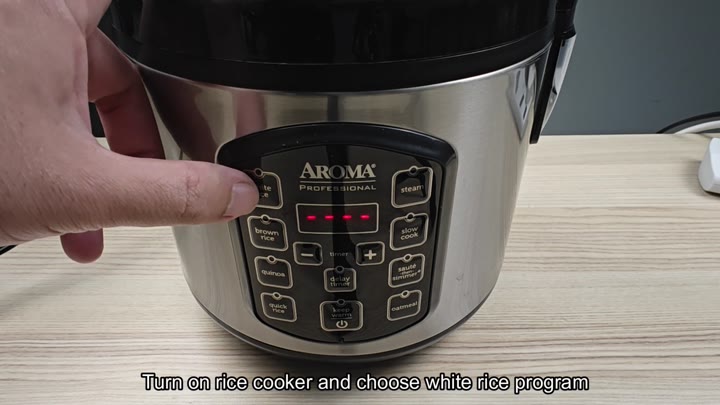 Pressing white rice button on cooker Pressing white rice button on cooker