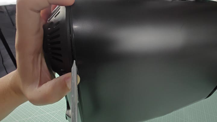 Prying open the black appliance casing Prying open the black appliance casing