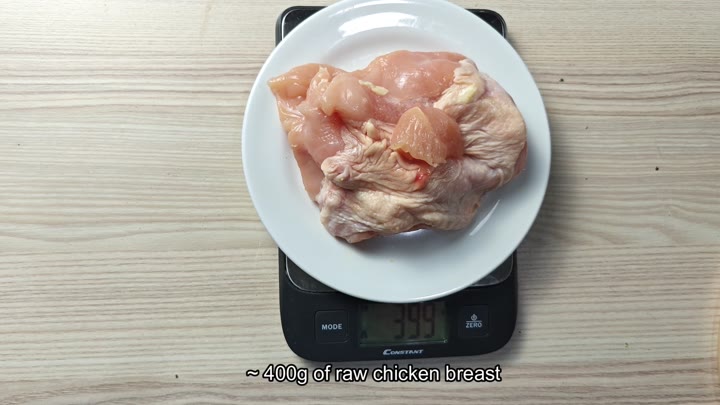 Raw chicken breast on digital scale Raw chicken breast on digital scale