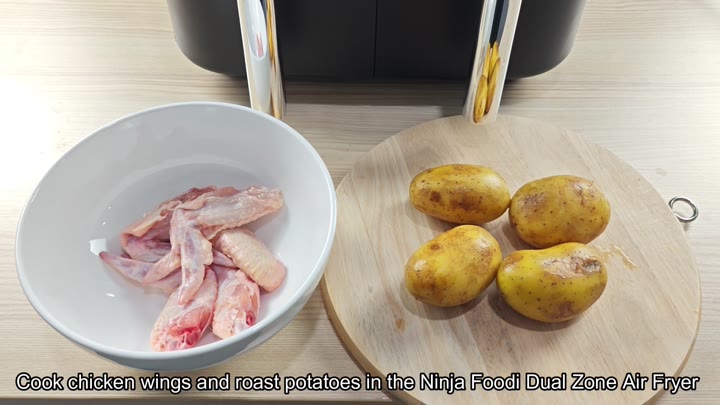 Raw wings and potatoes beside Ninja Foodi Raw wings and potatoes beside Ninja Foodi