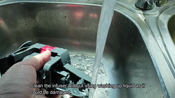 Rinsing infuser under running water Rinsing infuser under running water